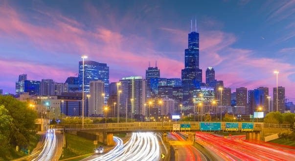 Willis Tower and the Chicago skyline at dusk above the expressway